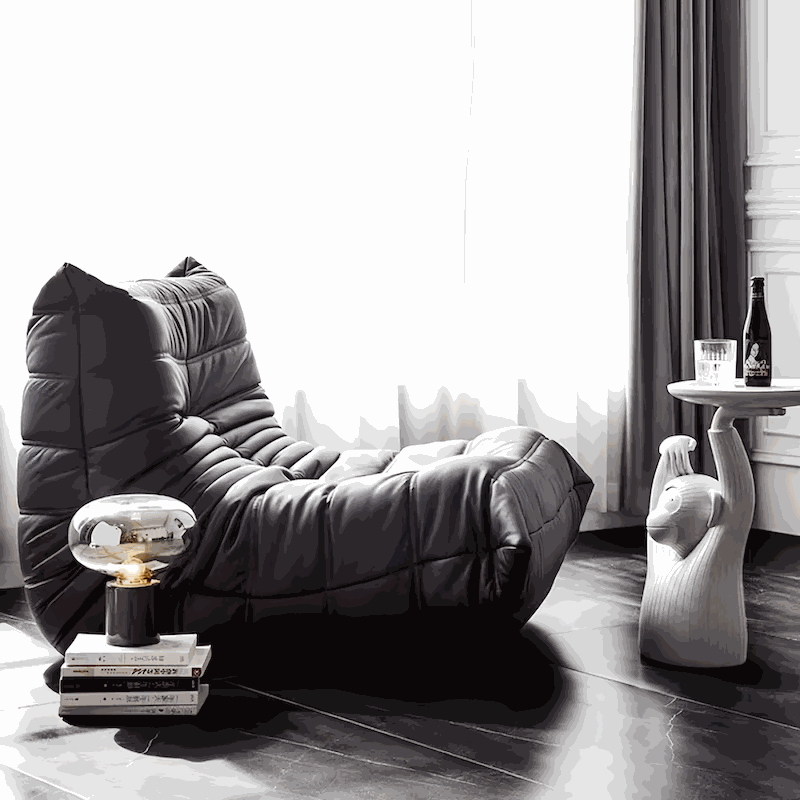 Black Togo Chair fiber leather replica with ergonomic foam design in modern living room setting