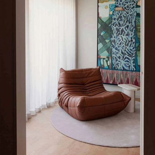 Togo Fireside Chair leather in modern living room with soft, body-hugging design